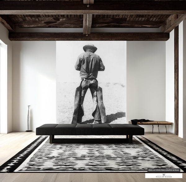 Vintage black and white mural of a Texas cowboy in chaps for Western decor.