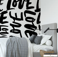 Black and white 'Love' mural creating a striking accent wall in a modern farmhouse.
