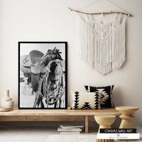 Vintage Western saddle on fence canvas print in black and white.