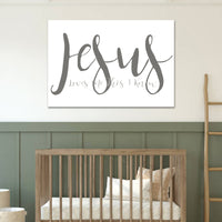 Nursery with a wooden crib and 'Jesus' wall art