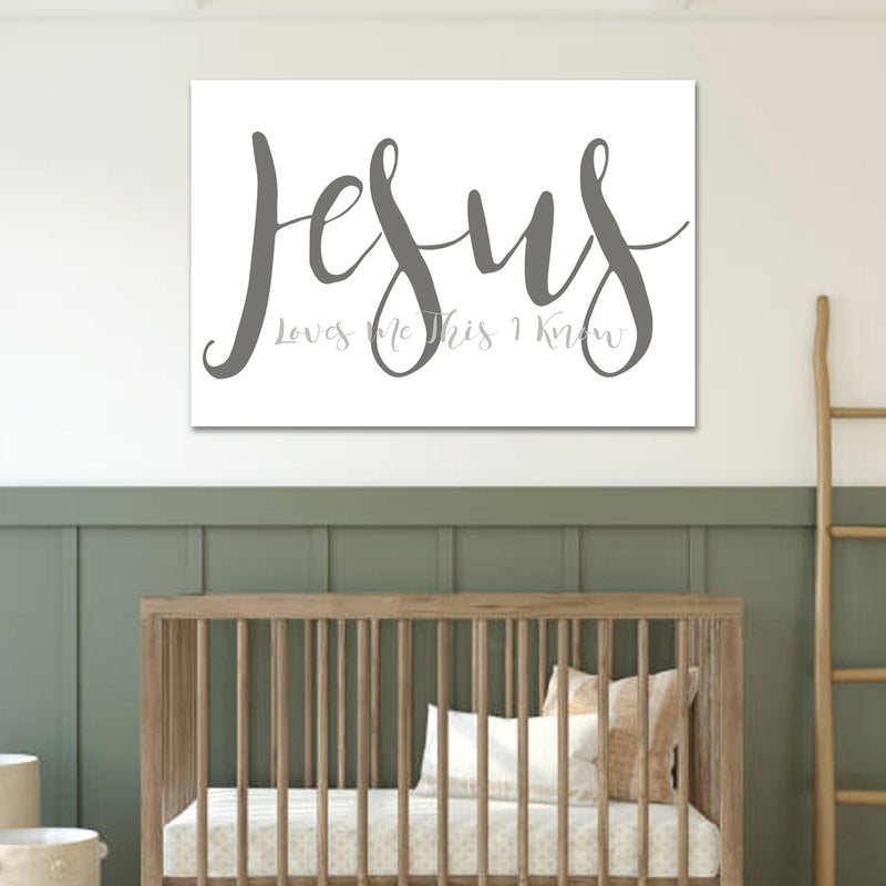Nursery with a wooden crib and 'Jesus' wall art