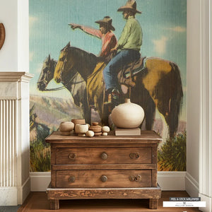 Vintage cowboys on mountain mural in muted colors for Western decor.