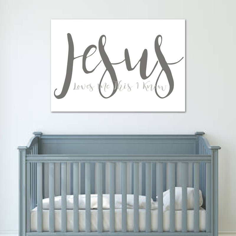 Gray crib with a 'Jesus Loves You This Much' sign on a white wall