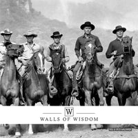 High-contrast black and white cowboy mural with riders on horseback