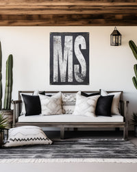 Durable 'MS' Mississippi banner with bold white letters on a weathered black backdrop, perfect for outdoor patios or indoor decor.
