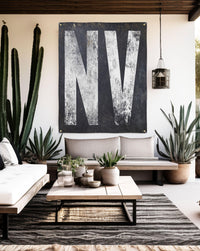 Elegant 'NV' backyard bar sign, blending Nevada's western typography with boho charm, a standout new home decor piece.