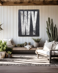 Wyoming 'WY' vinyl banner, with white on black for a touch of wilderness, weatherproof for both indoor and outdoor decor."
