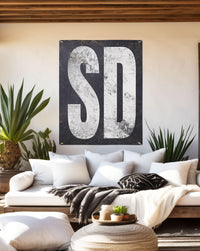 Rustic 'SD' vinyl patio sign, blending Western charm with minimalist design for an elegant backyard speakeasy or garden.