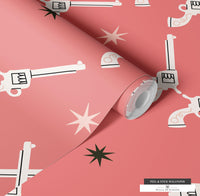 Unique removable wallpaper with pink and cream pistols and black stars for a retro western look.